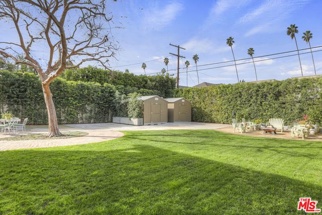 a view of a patio with table and chairs and potted plants