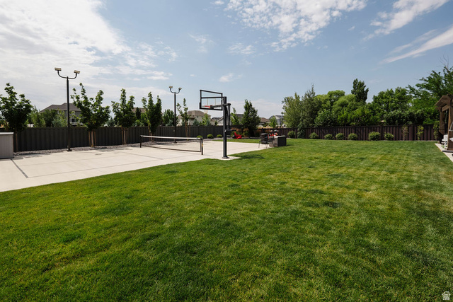 924 Country Lane Farmington, UT 84025 - Photo 88 of 91 Expansive lawn area with a concrete sports court featuring a basketball hoop and volleyball net