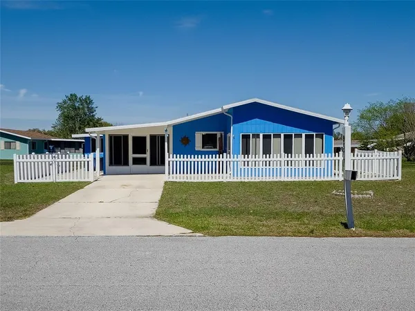 a front view of a house with a garden and yard