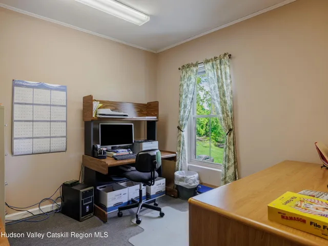 a bedroom with a workspace