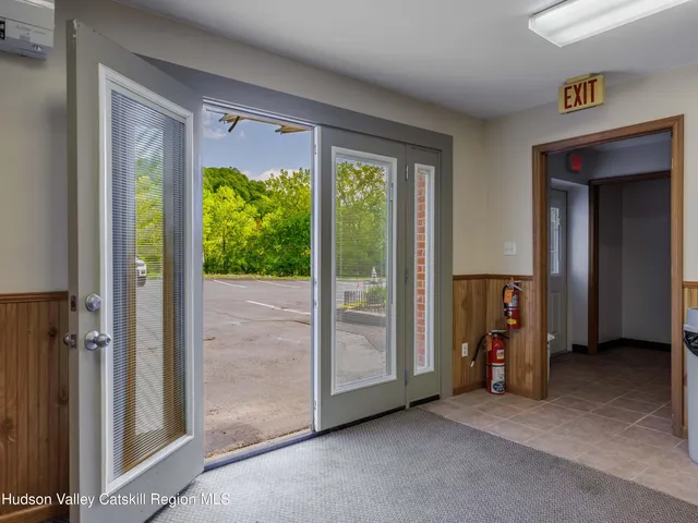 a view of an empty room with a fireplace and a large window