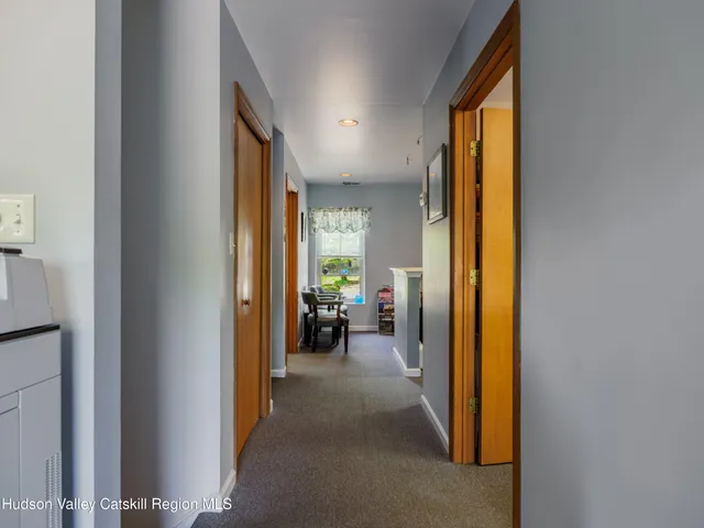 a view of a hallway with living room and filled with furniture