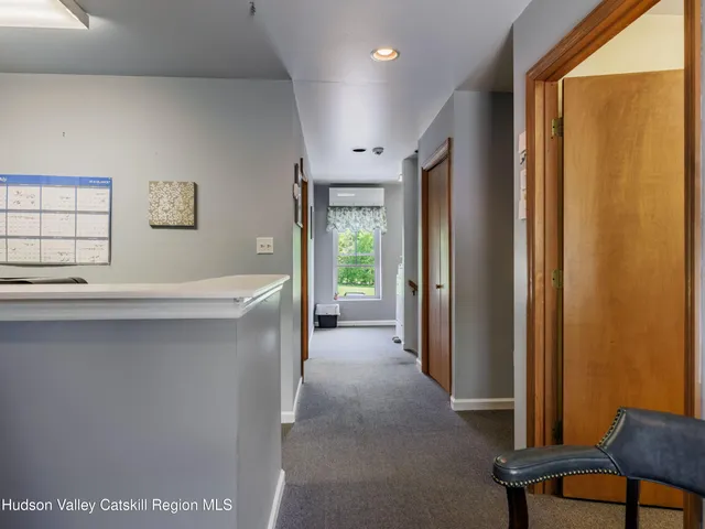 a view of hallway with furniture and a window