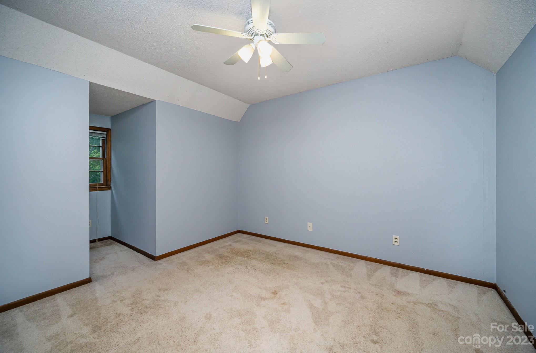 427 Laurel Hills Road Indian Land, SC 29707 - Photo 17 of 32 an empty room with a chandelier fan and windows