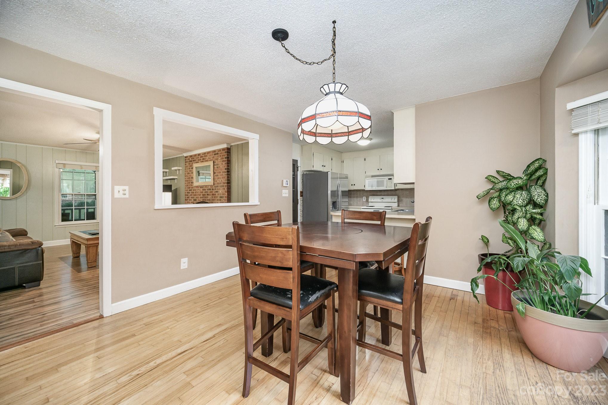 427 Laurel Hills Road Indian Land, SC 29707 - Photo 9 of 32 a view of a dining room with furniture wooden floor and chandelier
