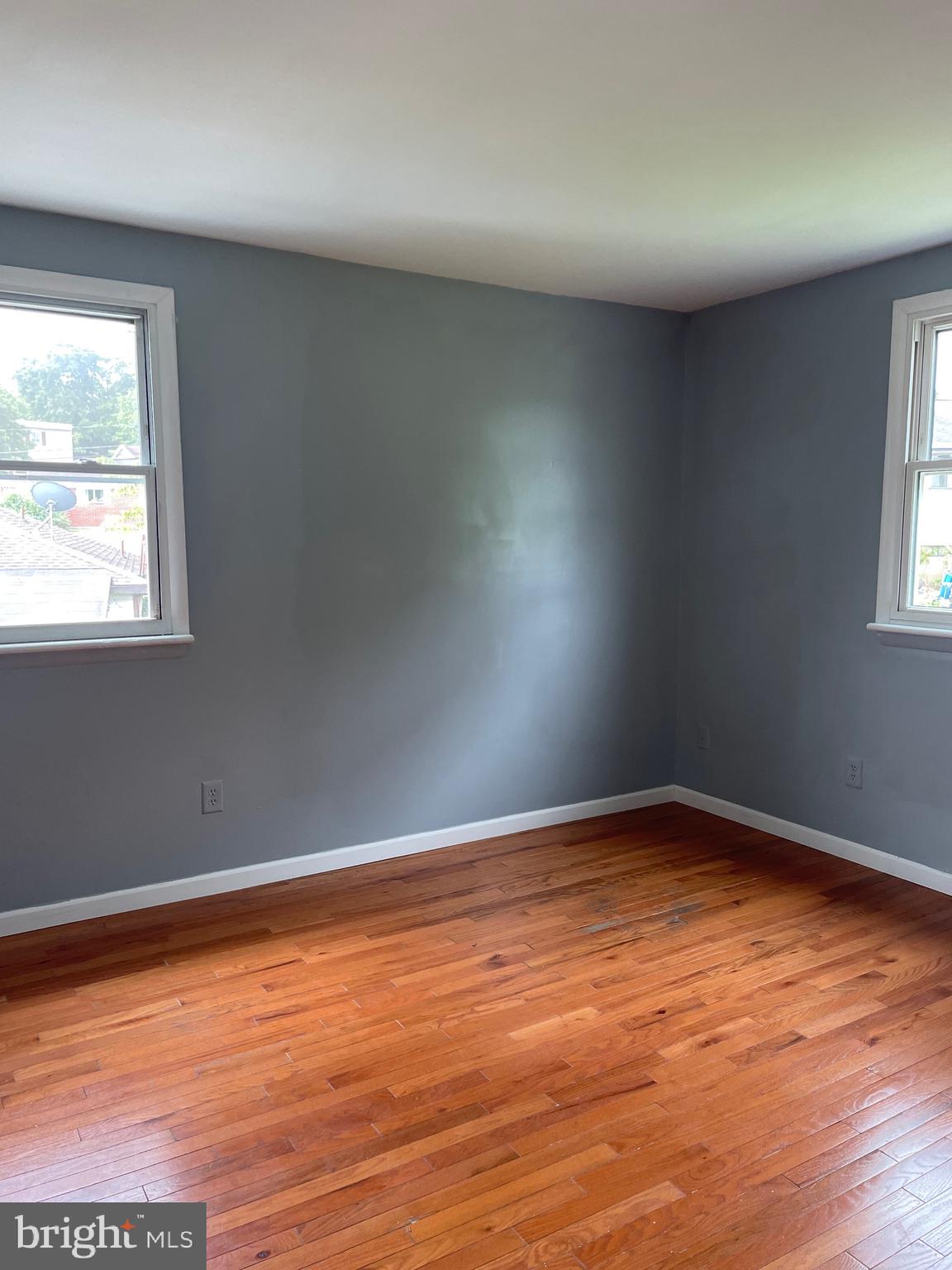 762 Erford Road Camp Hill, PA 17011 - Photo 4 of 25 an empty room with wooden floor and windows