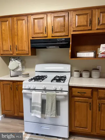 a kitchen with stainless steel appliances a stove a sink and a refrigerator