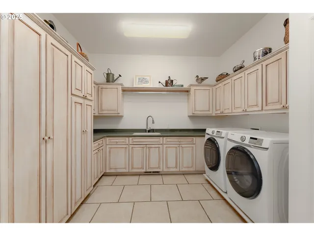 a kitchen with granite countertop a sink a stove and cabinets