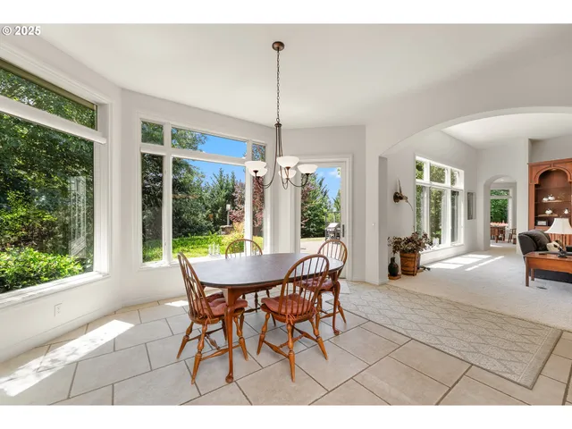 a dining room with furniture wooden floor and a chandelier