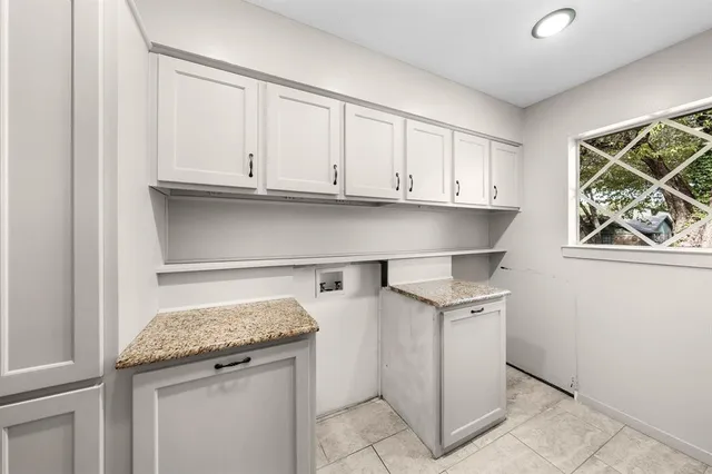 a view of a room with wooden floors and kitchen view