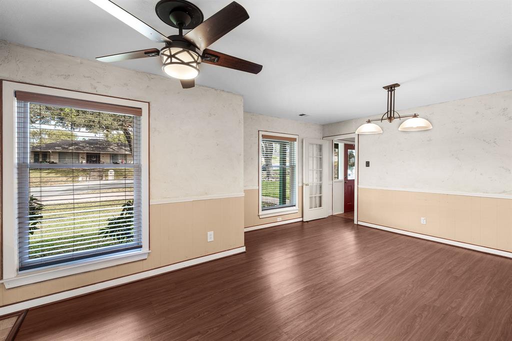 207 Summit Ridge Drive Rockwall, TX 75087 - Photo 13 of 28 a view of an empty room with window and wooden floor