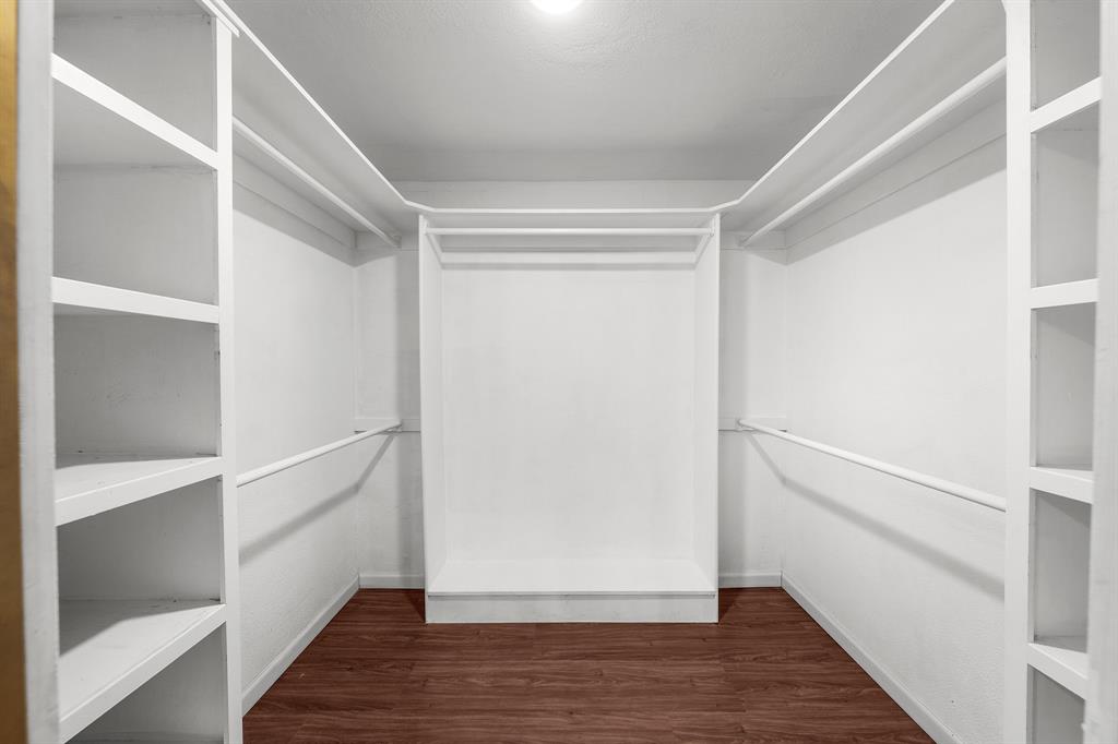 207 Summit Ridge Drive Rockwall, TX 75087 - Photo 20 of 28 a view of walk in closet with wooden floor