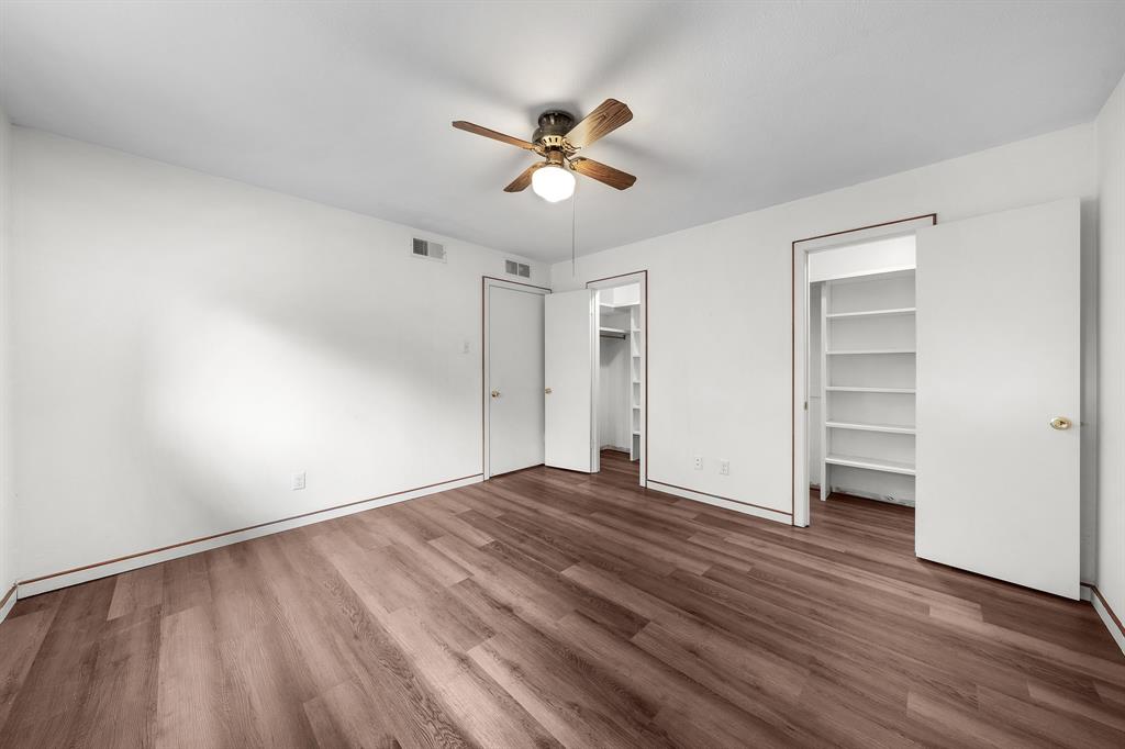 207 Summit Ridge Drive Rockwall, TX 75087 - Photo 21 of 28 a view of an empty room with a window and wooden floor