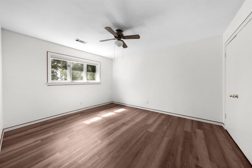 207 Summit Ridge Drive Rockwall, TX 75087 - Photo 23 of 28 a view of an empty room with wooden floor and a window