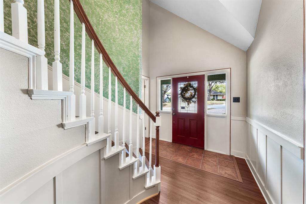207 Summit Ridge Drive Rockwall, TX 75087 - Photo 5 of 28 a view of staircase with lots of frames on wall and wooden floor
