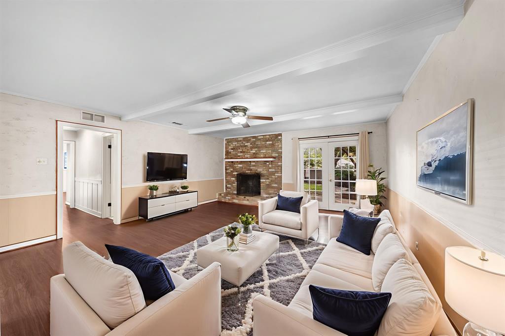 207 Summit Ridge Drive Rockwall, TX 75087 - Photo 6 of 28 a living room with furniture a flat screen tv and a fireplace