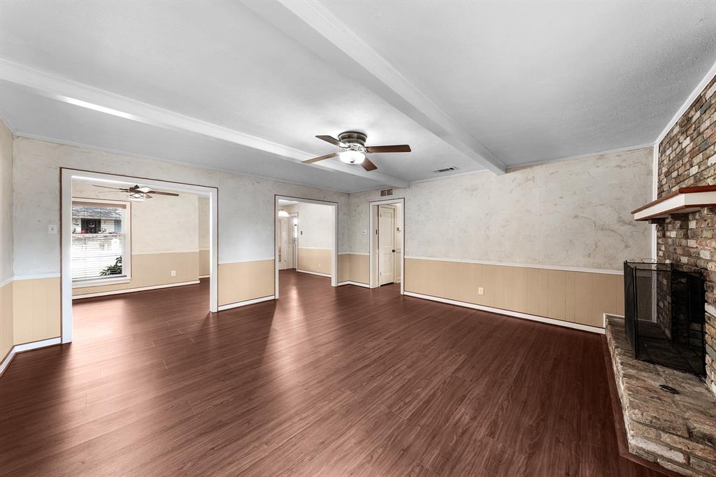 207 Summit Ridge Drive Rockwall, TX 75087 - Photo 7 of 28 a view of a livingroom with wooden floor and a ceiling fan