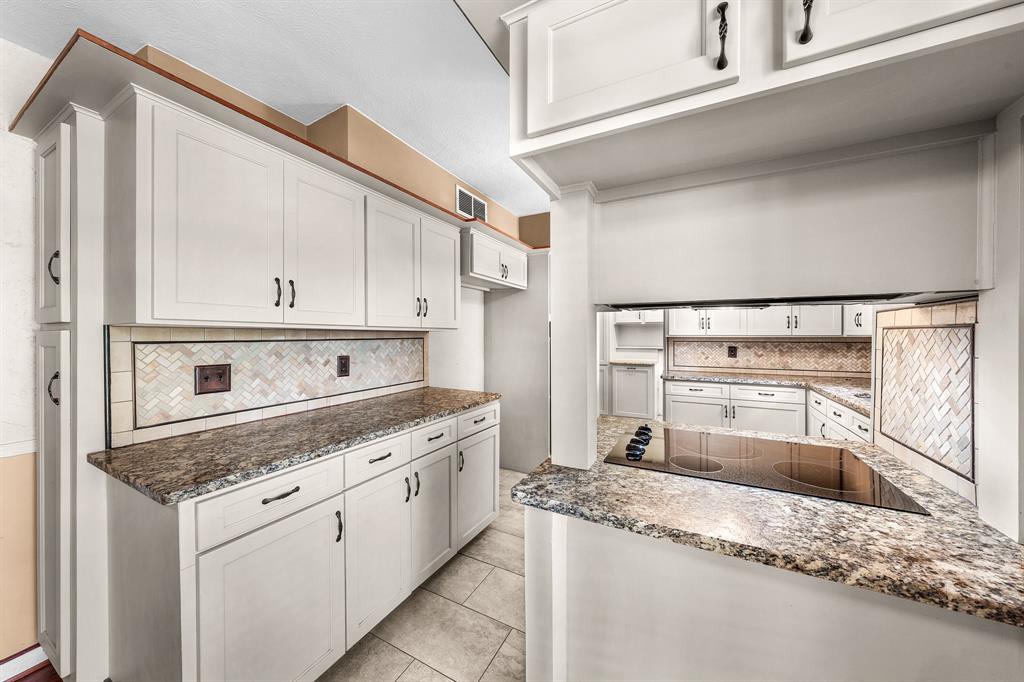 207 Summit Ridge Drive Rockwall, TX 75087 - Photo 9 of 28 a kitchen with granite countertop a sink and a stove top oven