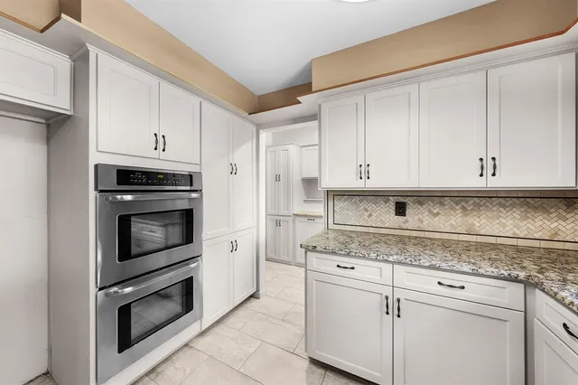 a kitchen with stainless steel appliances granite countertop a stove and a refrigerator