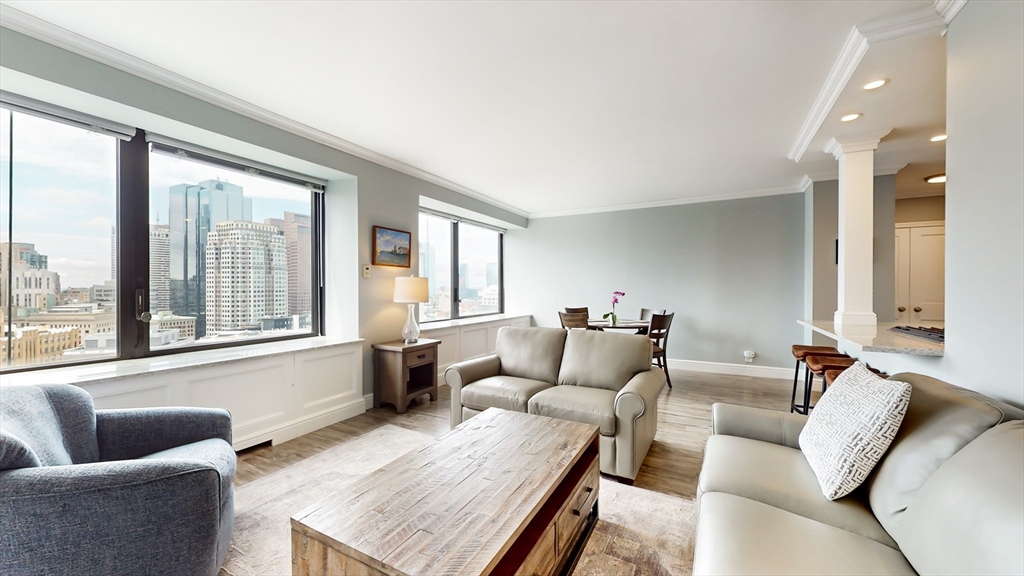 65 East India Row, Unit 24H Boston, MA 02110 - Photo 11 of 27 a living room with furniture and a large window