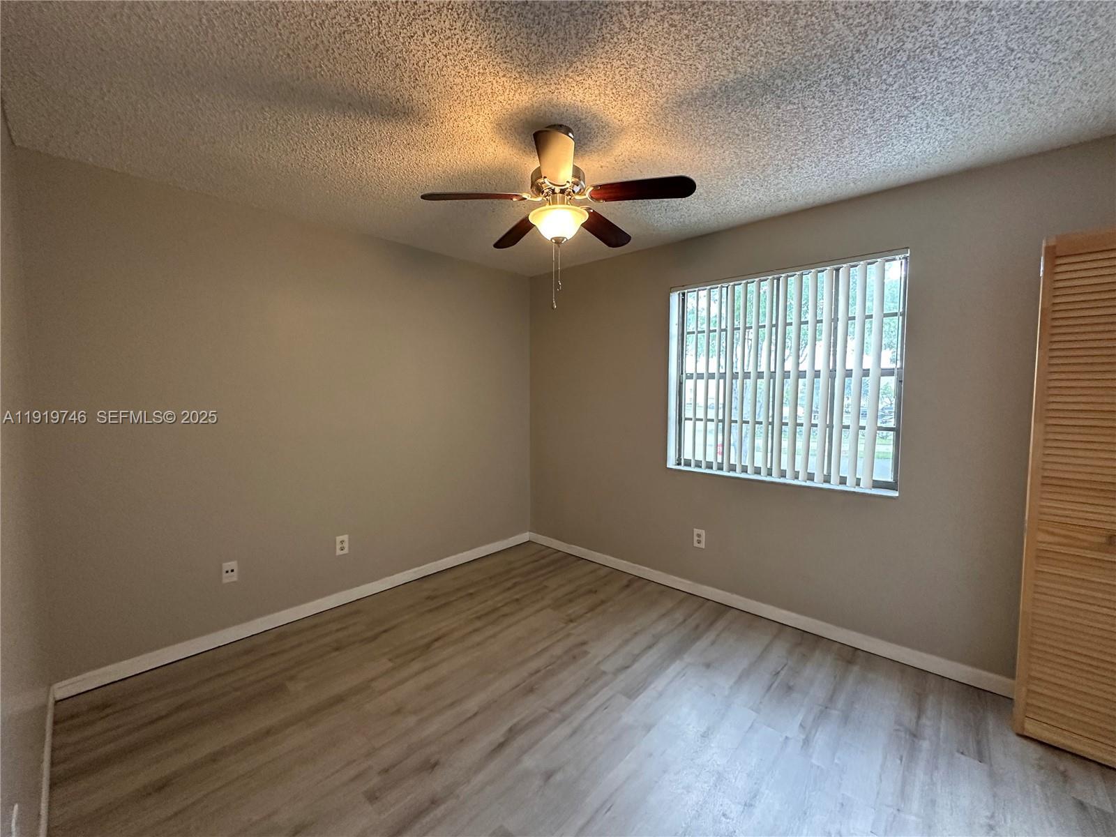 1024 South Independence Drive, Unit 1024A Homestead, FL 33034 - Photo 19 of 26 wooden floor in an empty room with a window