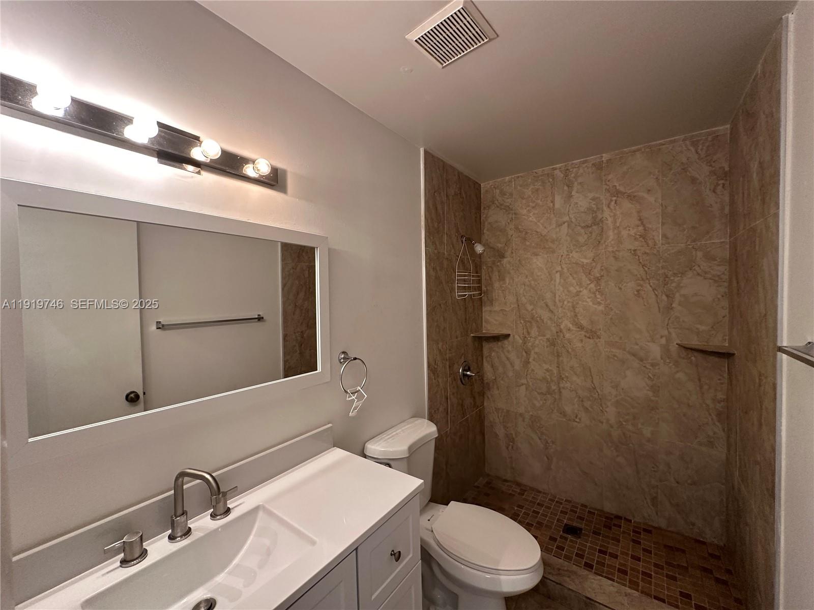 1024 South Independence Drive, Unit 1024A Homestead, FL 33034 - Photo 21 of 26 a bathroom with a sink a toilet and shower