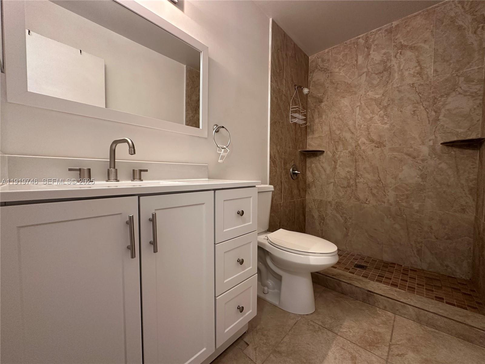 1024 South Independence Drive, Unit 1024A Homestead, FL 33034 - Photo 22 of 26 a bathroom with a toilet sink and mirror