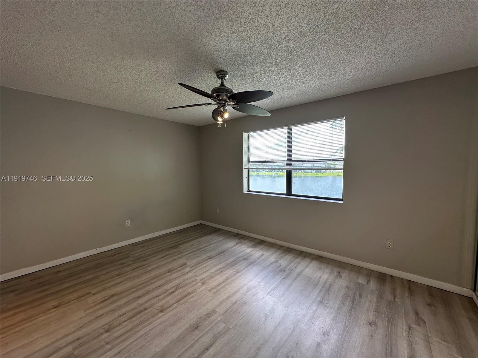 1024 South Independence Drive, Unit 1024A Homestead, FL 33034 - Photo 9 of 26 wooden floor in an empty room with a window