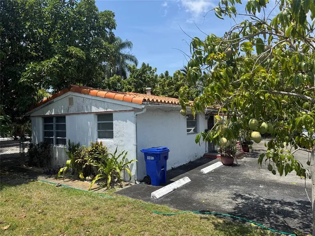a view of a house with a yard and sitting area