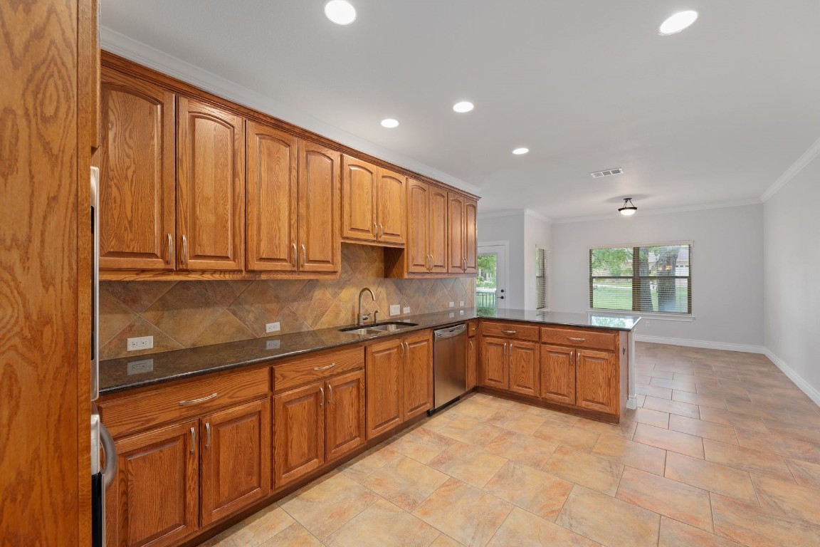 1001 Fort Davis Street Georgetown, TX 78633 - Photo 20 of 40 a large kitchen with stainless steel appliances granite countertop a sink and cabinets
