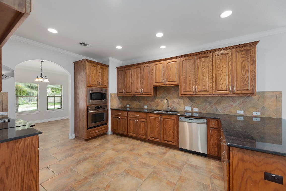 1001 Fort Davis Street Georgetown, TX 78633 - Photo 21 of 40 a kitchen with stainless steel appliances granite countertop a stove top oven a sink and dishwasher