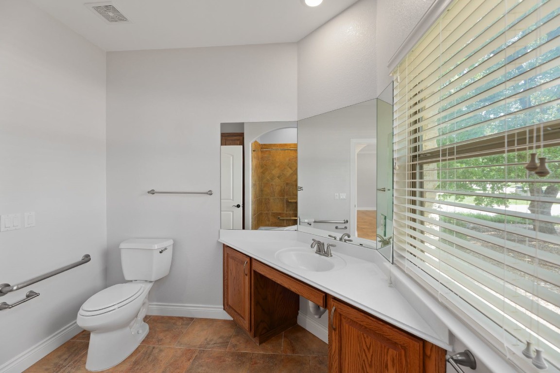 1001 Fort Davis Street Georgetown, TX 78633 - Photo 31 of 40 a bathroom with a sink a toilet and shower