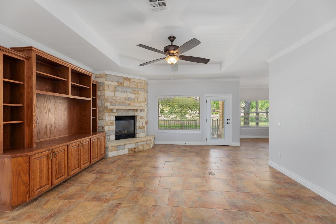 1001 Fort Davis Street Georgetown, TX 78633 - Photo 7 of 40 a view of a livingroom with an empty space and a kitchen space with a ceiling fan