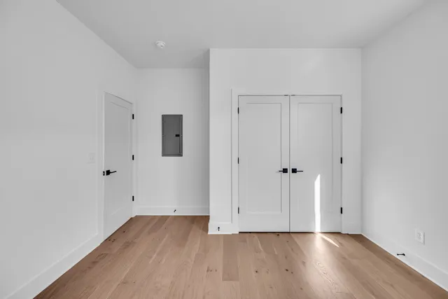 a room with stainless steel appliances kitchen island granite countertop a table and chairs in it