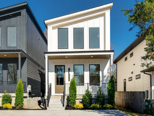 a view of a hallway with wooden floor and a living room