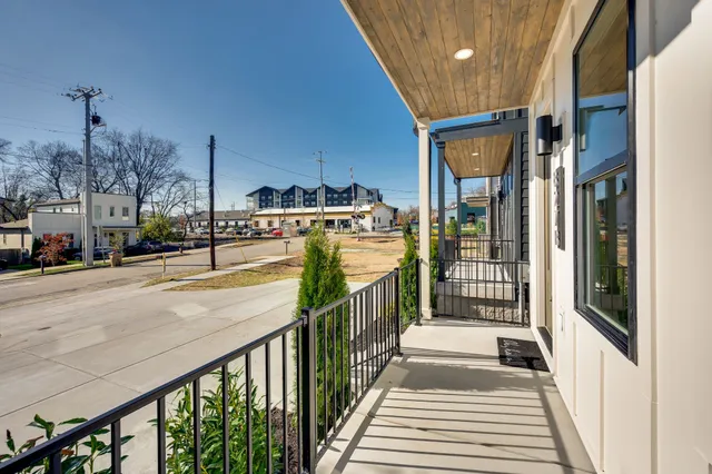 a kitchen with stainless steel appliances a dining table chairs and chandelier