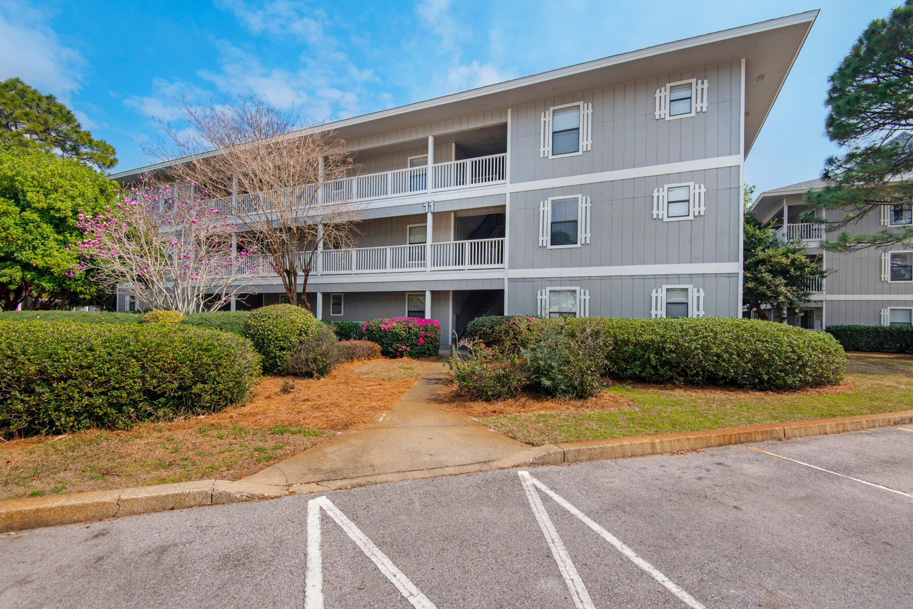 3799 East County Highway 30A, Unit E11 Santa Rosa Beach, FL 32459 - Photo 1 of 31 a front view of a building with garden
