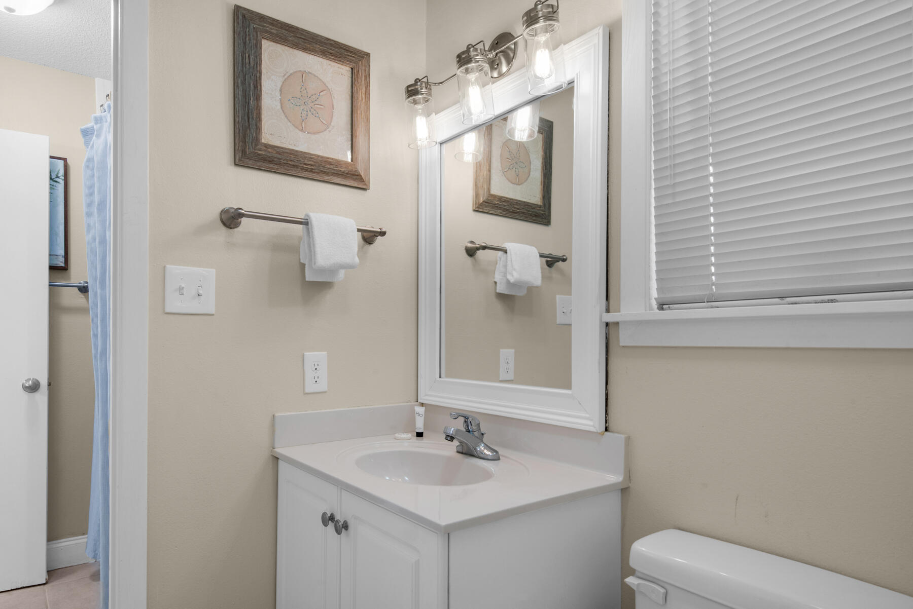 3799 East County Highway 30A, Unit E11 Santa Rosa Beach, FL 32459 - Photo 29 of 31 a bathroom with a sink toilet and mirror
