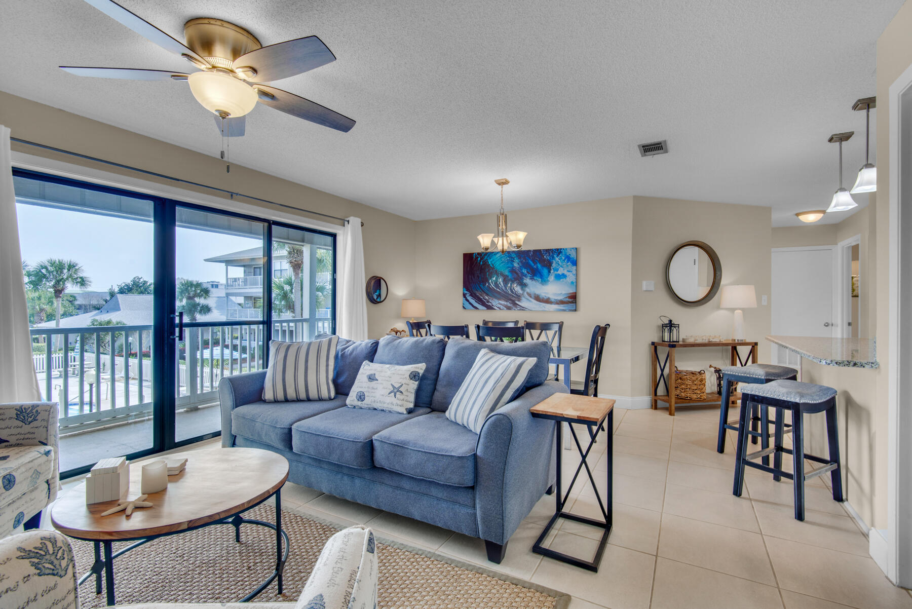 3799 East County Highway 30A, Unit E11 Santa Rosa Beach, FL 32459 - Photo 3 of 31 a living room with furniture a chandelier fan and a large window