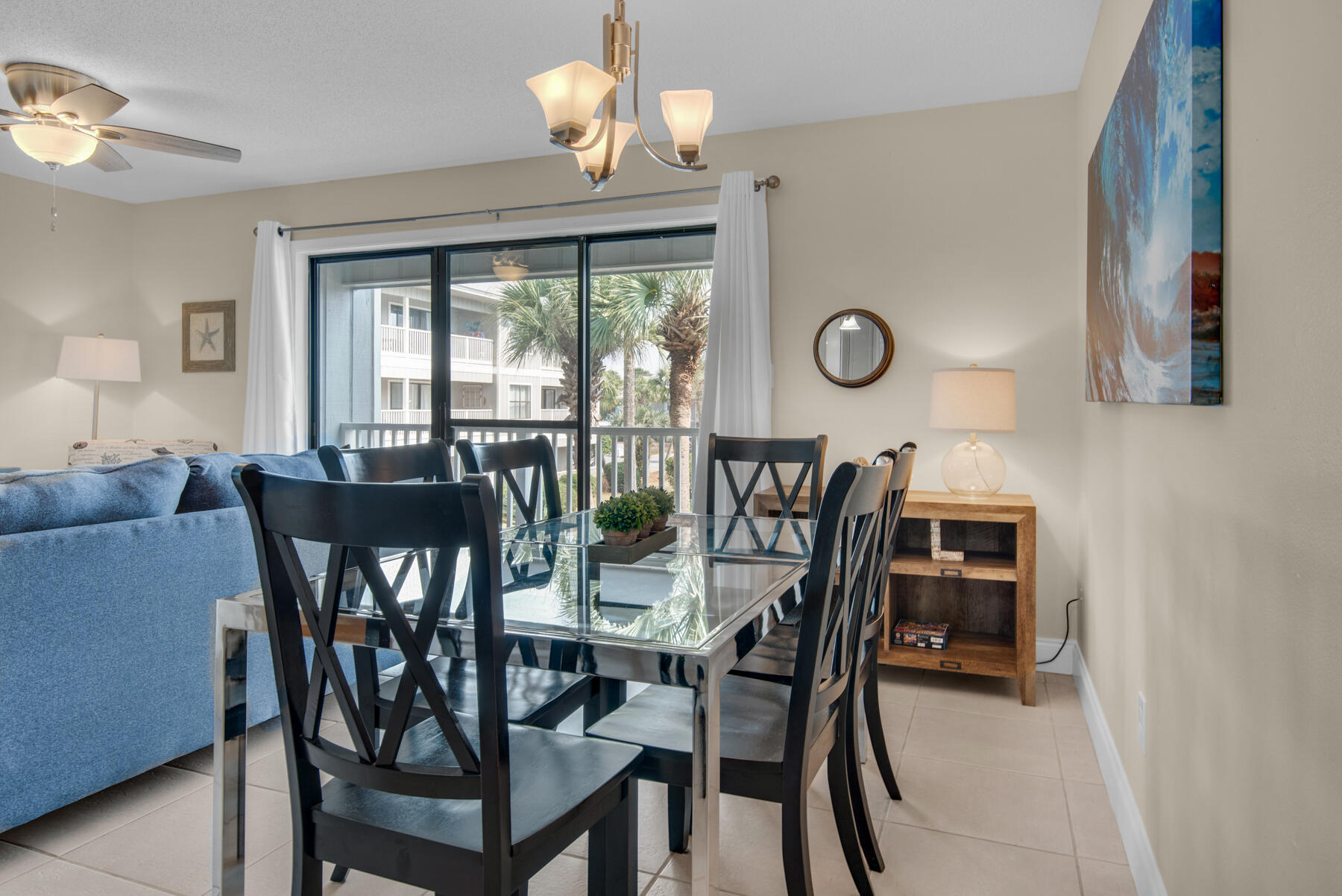 3799 East County Highway 30A, Unit E11 Santa Rosa Beach, FL 32459 - Photo 9 of 31 a view of a dining room with furniture wooden floor and chandelier