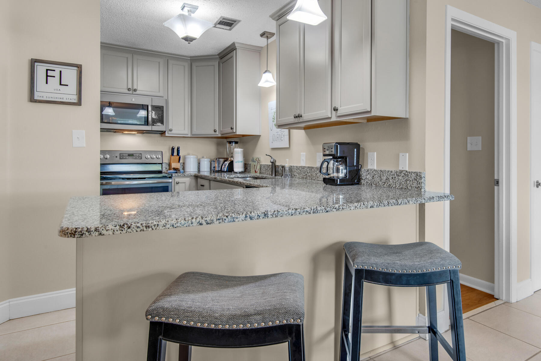 3799 East County Highway 30A, Unit E11 Santa Rosa Beach, FL 32459 - Photo 10 of 31 a kitchen with granite countertop stainless steel appliances a sink and cabinets