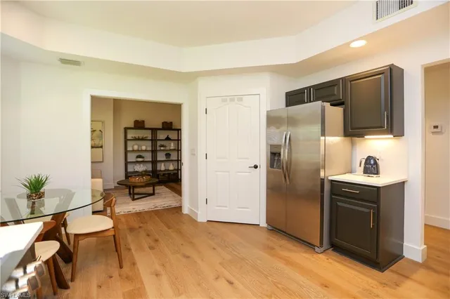 a kitchen with stainless steel appliances a refrigerator and a stove top oven