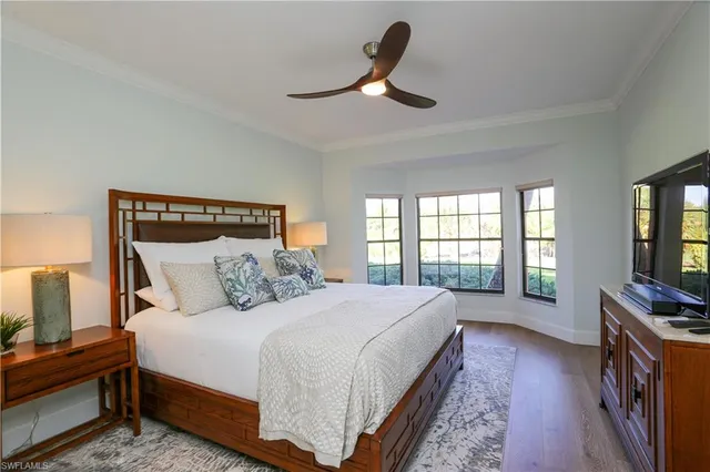 a bedroom with a large bed and a large window