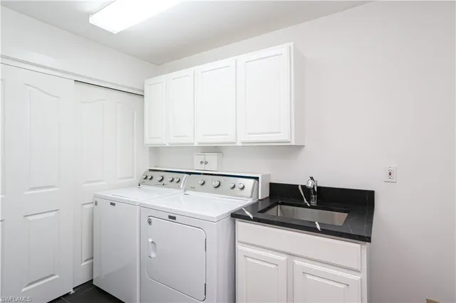 a view of a storage and utility room with washer and dryer