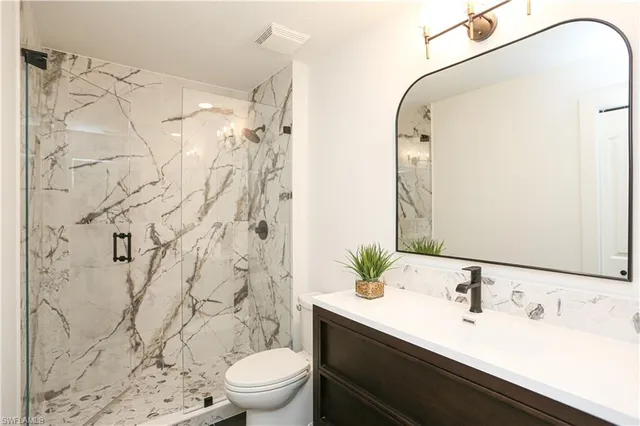 a bathroom with a sink toilet and shower