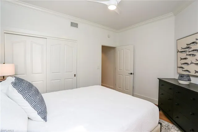 a bedroom with a bed and a desk