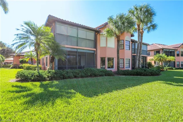 a front view of a residential houses with yard and green space
