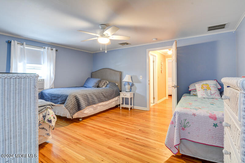 419 Jersey Avenue Spring Lake, NJ 07762 - Photo 18 of 32 a bedroom with a bed and wooden floor