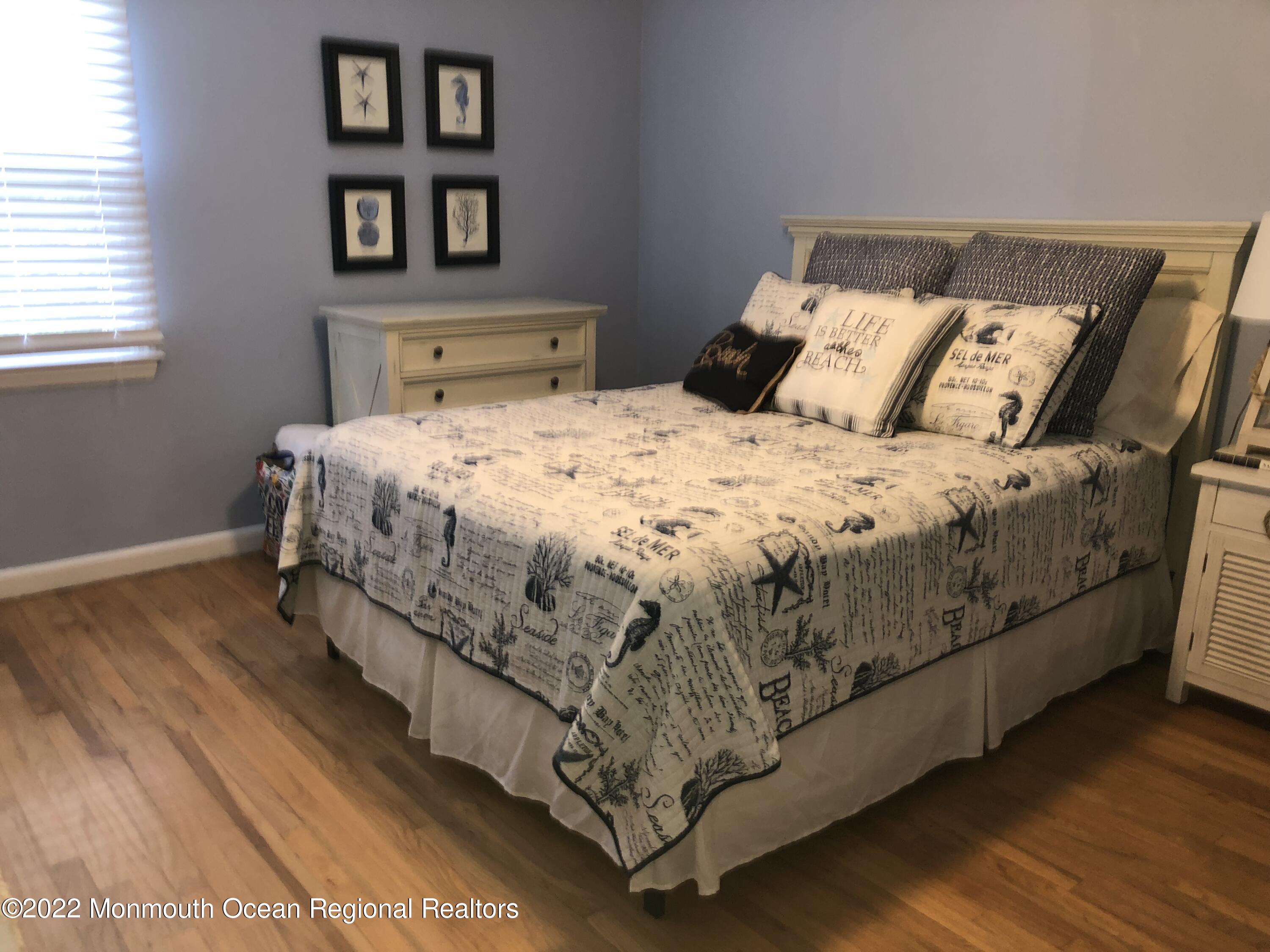 419 Jersey Avenue Spring Lake, NJ 07762 - Photo 19 of 32 a bedroom with a bed and a night stand