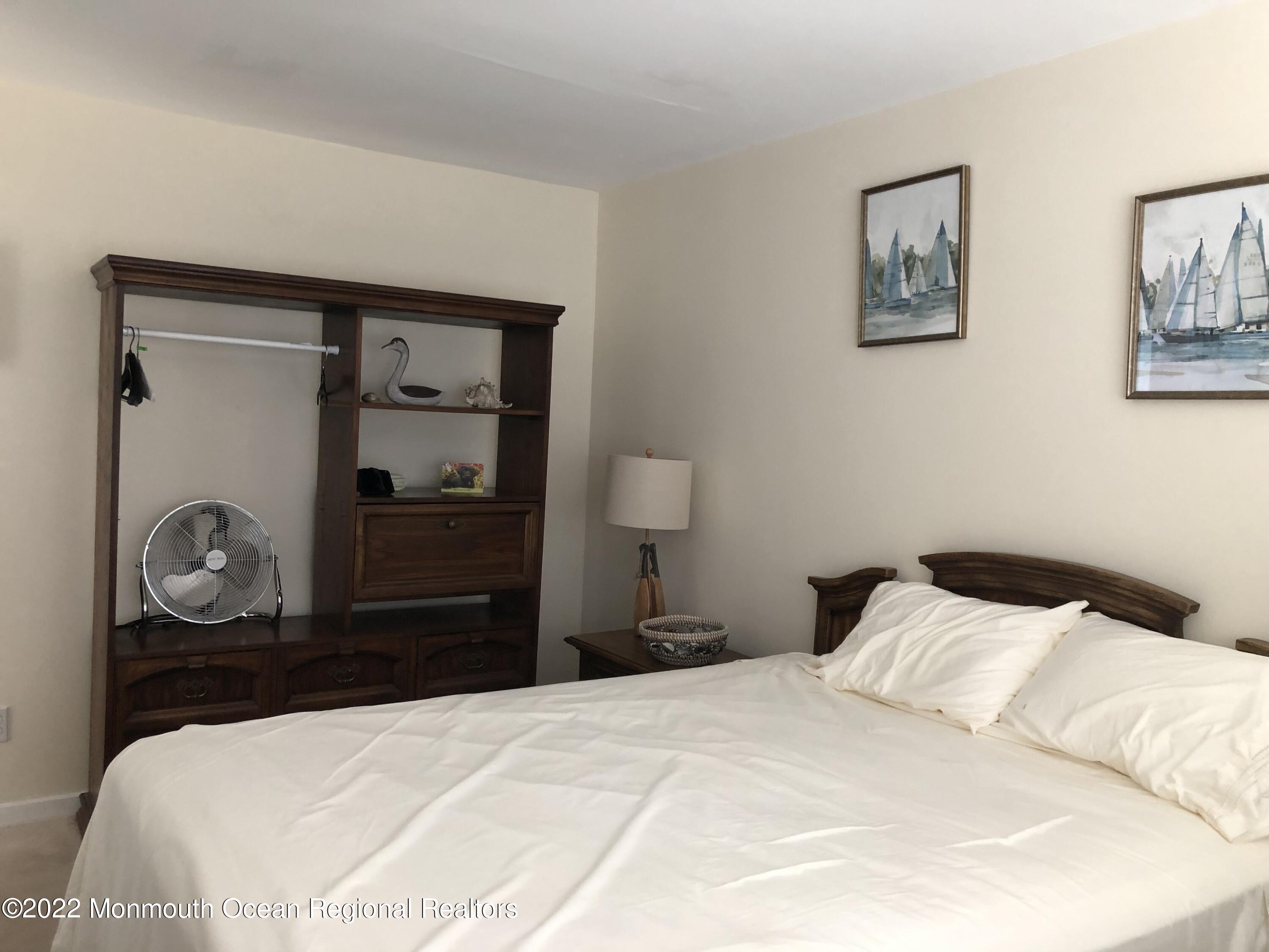 419 Jersey Avenue Spring Lake, NJ 07762 - Photo 20 of 32 a bedroom with a bed and a mirror